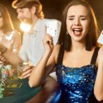 Group of an elegant people playing poker at the gambling house.