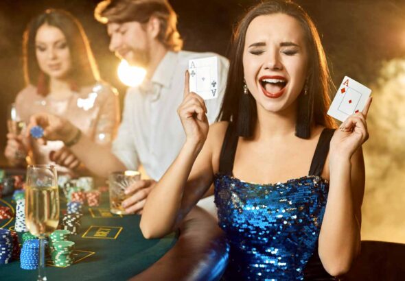 Group of an elegant people playing poker at the gambling house.
